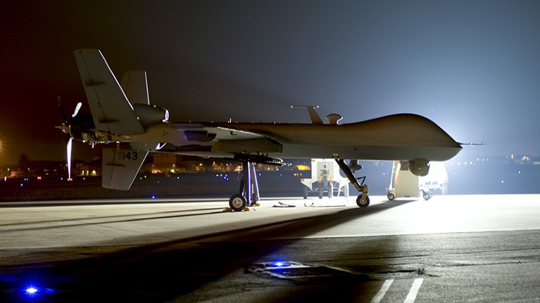 An MQ-9 Reaper sits on the flight line at Hurlburt Field with mounted surveillance equipment