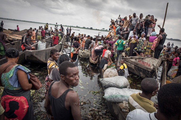 A busy riverside with moored boats and stalls selling food at Mbandaka in the Democratic Republic of Congo