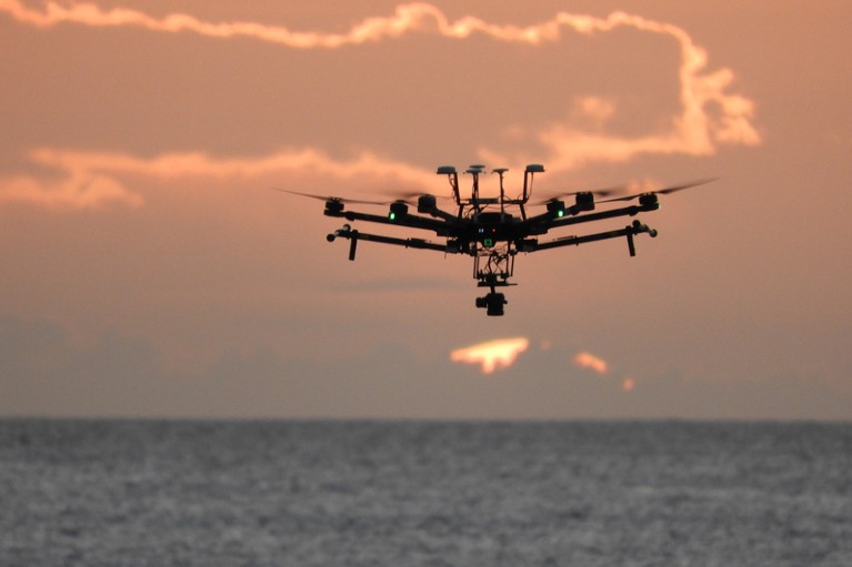 A drone flying over the ocean gathering data