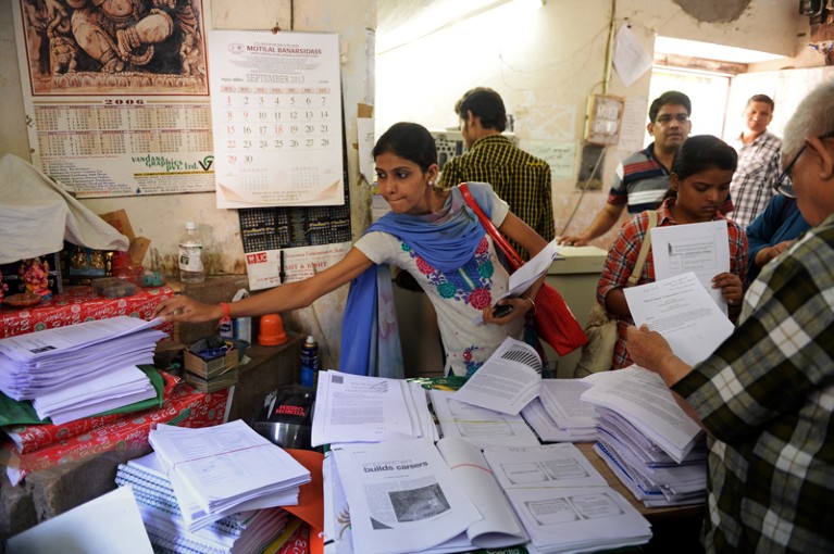 Indian students pick up photocopied material from the Rameshwari Photocopy Service shop