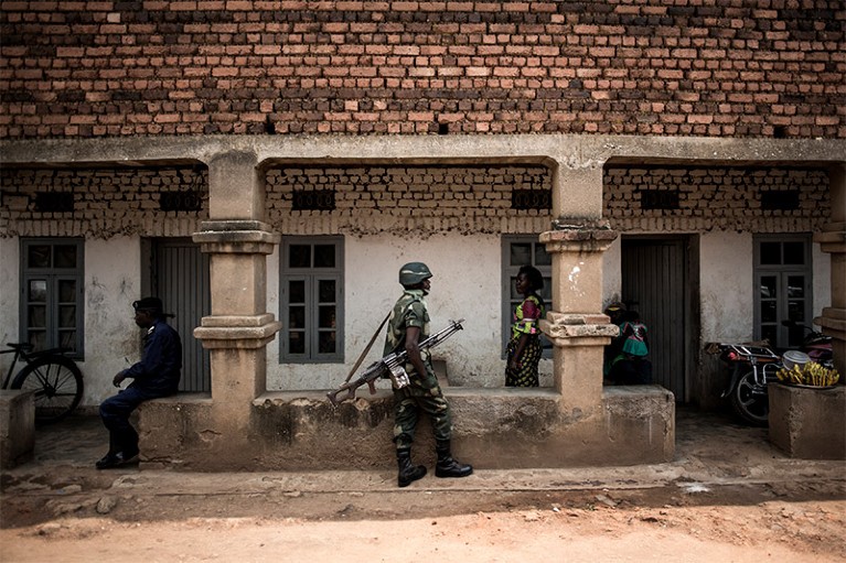 A member of the Government forces patrols near a health centre in Butembo.