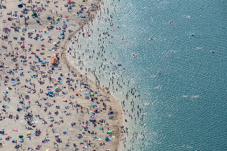 Bathers swim in the Silbersee II lake on July 25, 2019 near Marl, Germany.