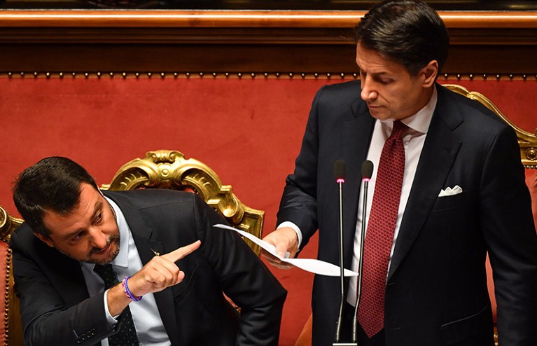 Italian Prime Minister Giuseppe Conte delivers a speech at the Italian Senate flanked by Deputy Prime Minister Matteo Salvini