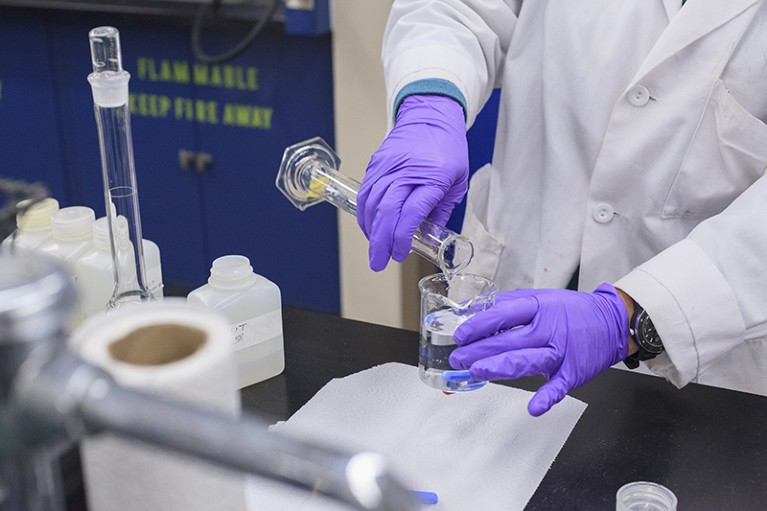 Closeup of a laboratory technician mixing reagents.