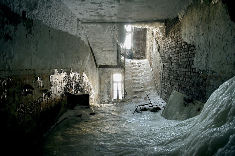The interior of an abaondoned multi storey building in Norilsk covered in ice