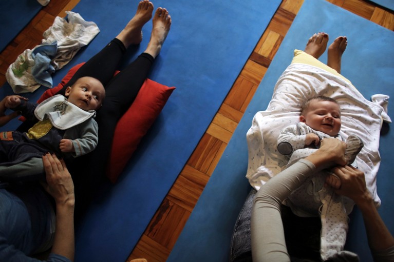 Mothers with babies attend a yoga session