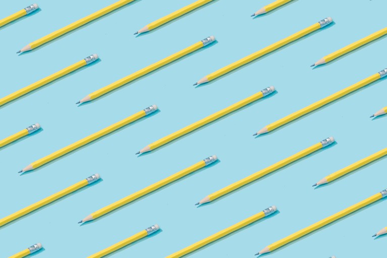 Pattern composition of yellow pencils on pastel blue background