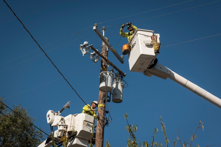 Workers repair a power transformer in California