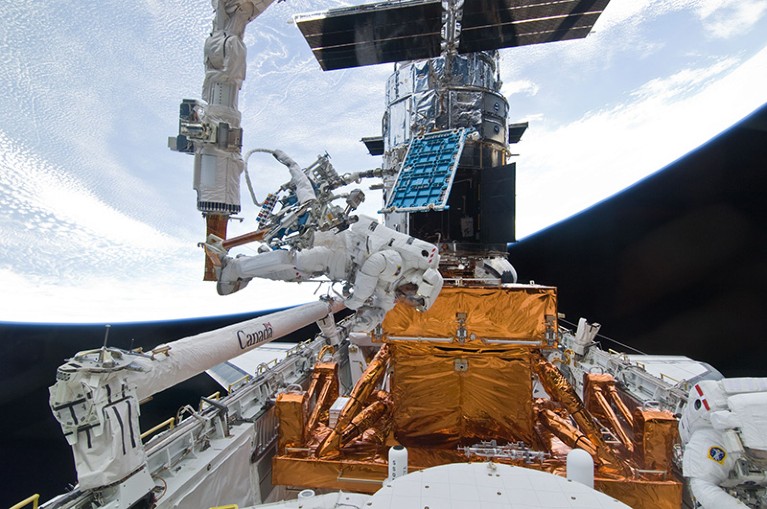 Astronauts on the Space Shuttle Atlantis refurbish and upgrade the Hubble Space Telescope.