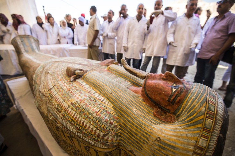 People observe a sarchphagus displayed in front of Hatshepsut Temple in Egypt's valley of the Kings in Luxor