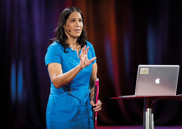 Wanda Diaz-Merced giving a talk at a conference