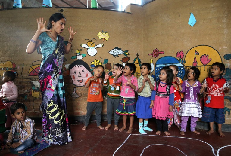A teacher leads a lesson at Katha Community School in the Govindpuri slum district of Delhi, India