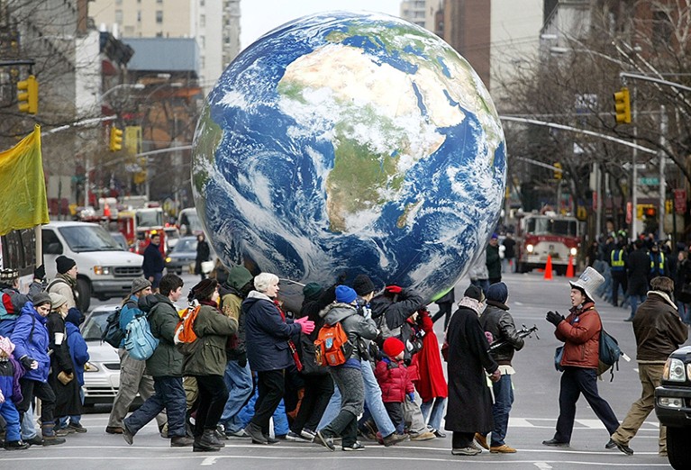 Demonstrators carry an inflatable globe during a protest in New York City