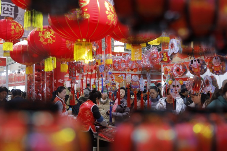 People shop for decorations for the upcoming Chinese Lunar New Year at a market in Beijing, China