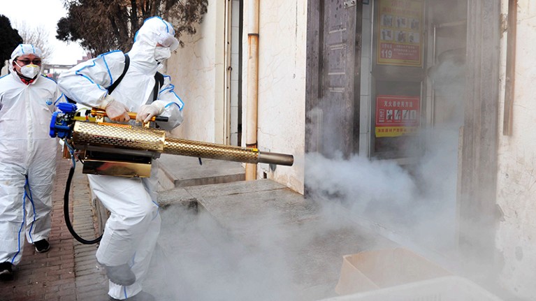 A Qingdao Coronavirus volunteer in a protective suit disinfects a neighborhood in Qingdao, China.