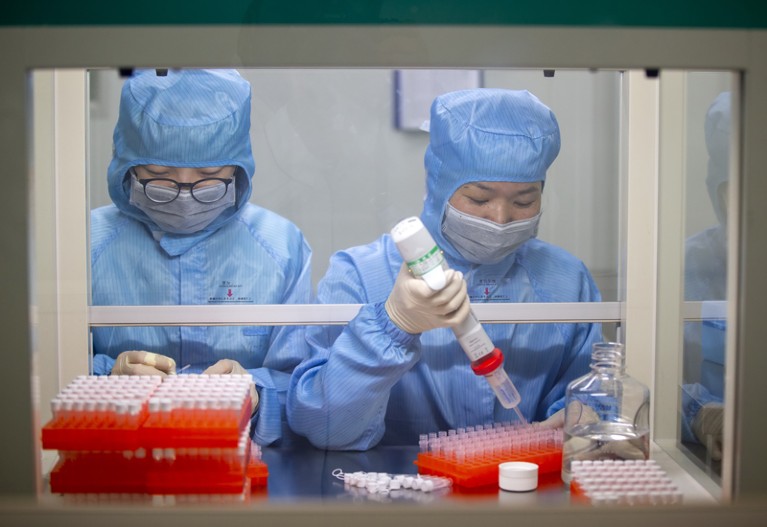 Jiangsu Shuoshi Biotechnology Co. Ltd. production workers working on a coronavirus nucleic acid detection kit, China