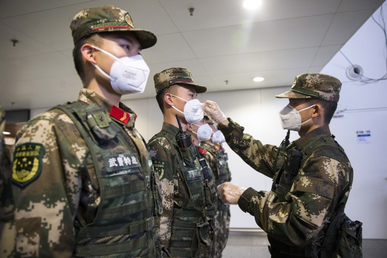 Chinese paramilitary policemen wearing face masks for prevention of the new coronavirus