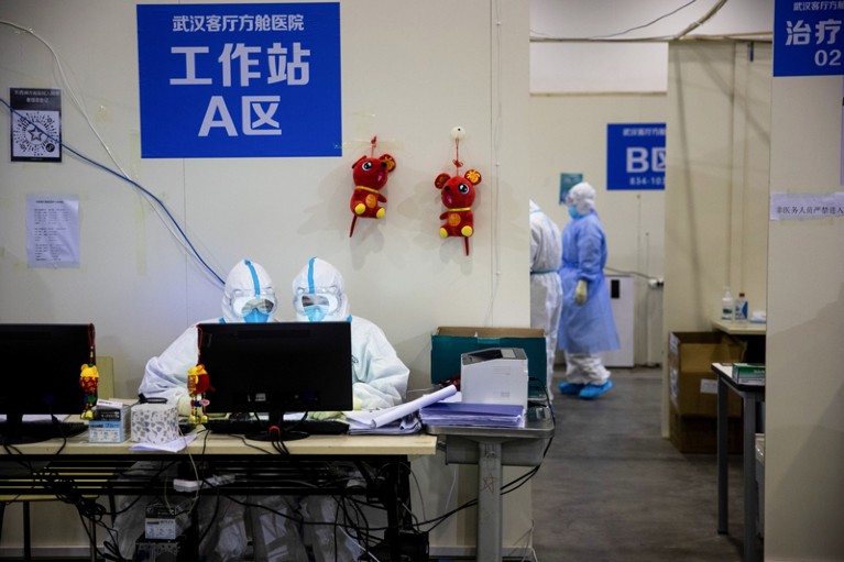 Medical staff members working at a computer in an exhibition centre converted into a hospital in Wuhan, China