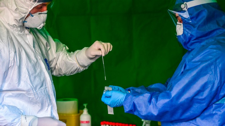 Medical workers prepare to perform drive-through swabbing tests in Alessandria, Piedmont.