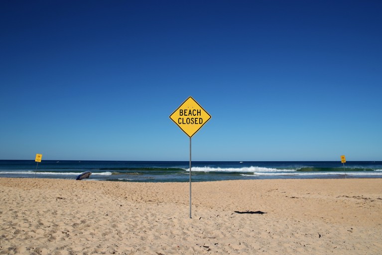 'Beach closed' sign on the desolate North Steyne Beach, Australia