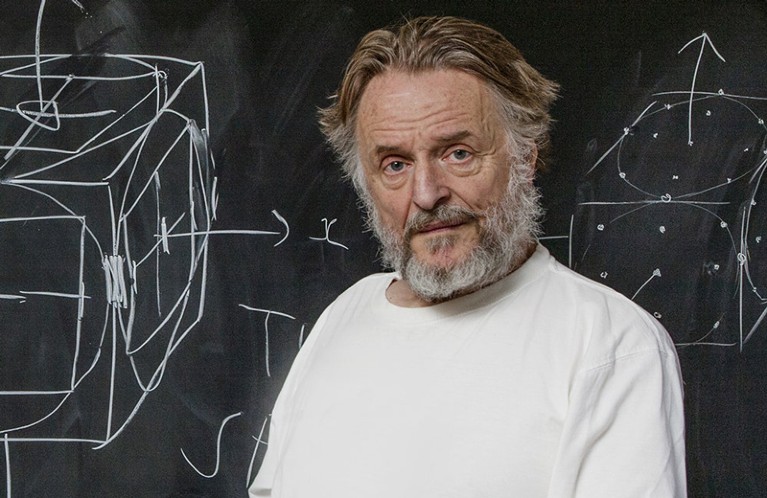 John Horton Conway standing in front of a blackboard with diagrams