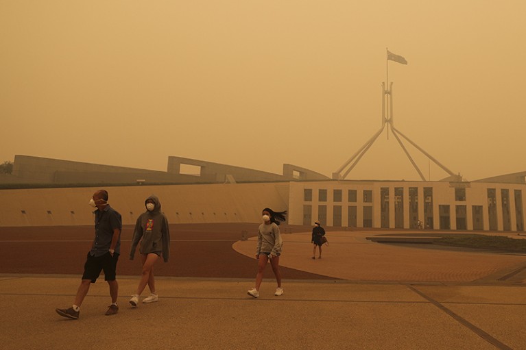 Visitors to Parliament House wear face masks after smoke from bushfires blankets Canberra, Australia.