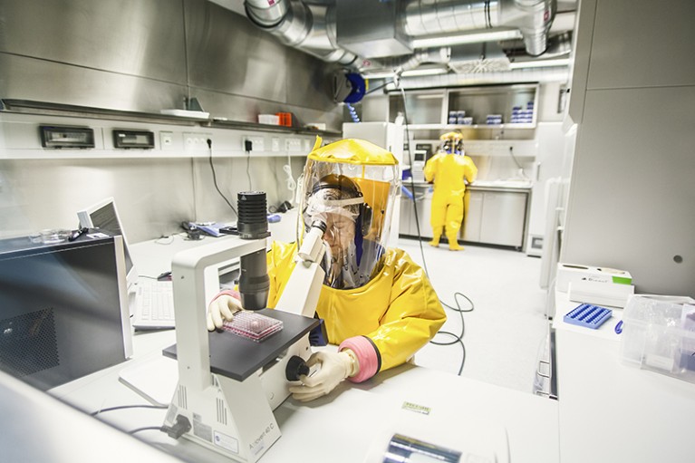 Two researchers in a high-security laboratory (BSL4-Lab)