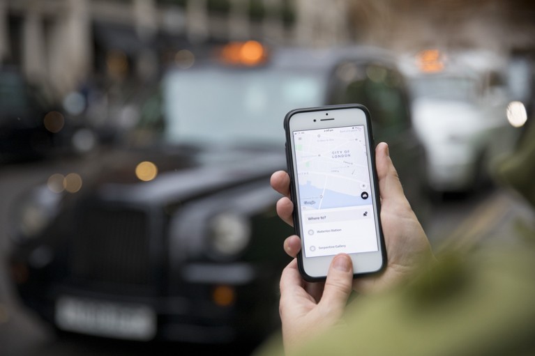 A commuter uses the Uber Technologies Inc. app on a smartphone