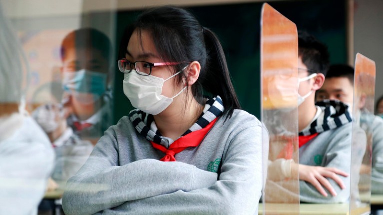 Students wearing face masks have a class at a middle school on April 27, 2020 in Shanghai, China.