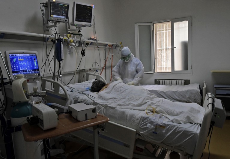 A Tunisian member of the medical staff attends to a coronavirus patient