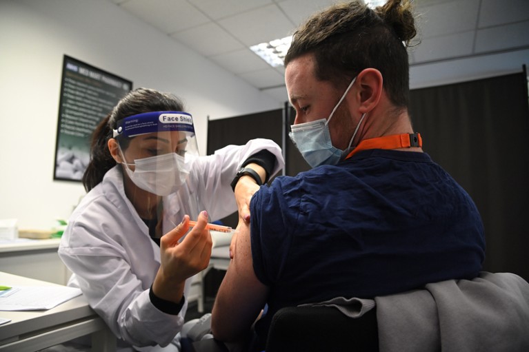 A care worker receives the Oxford-AstraZeneca Covid-19 vaccine