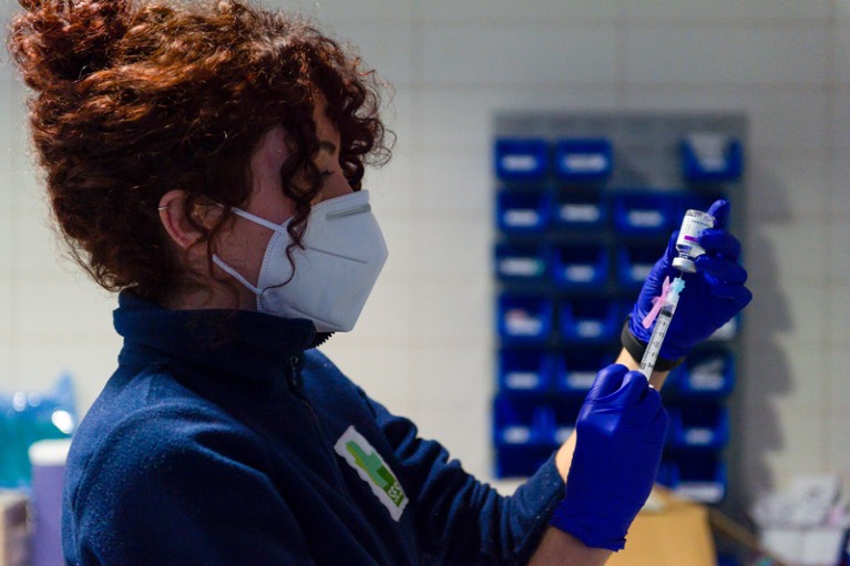 A healthcare worker prepares a syringe with the Astra Zeneca vaccine