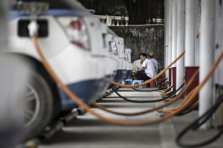 A fleet of cars is plugged in to be recharged