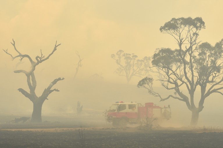 Fire engine surrounded by bushfire smoke, Australia
