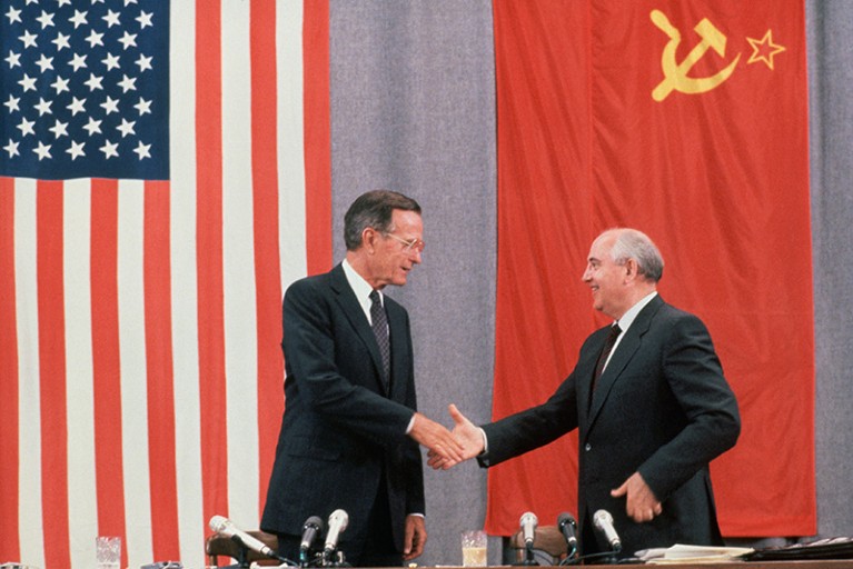 Presidents Bush and Gorbachev shake hands at the end of a press conference about the peace summit in Moscow on 31 July 1991