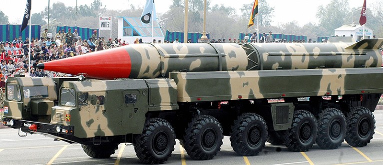 Pakistani spectators watch the Shaheen II long-range missile capable of carrying a nuclear warhead on its launcher at a parade.