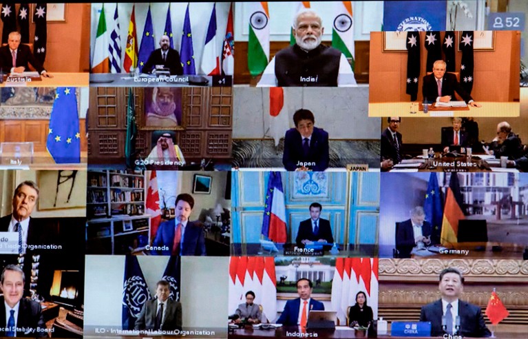 Leaders from different nations are seen on a screen during a videoconference call