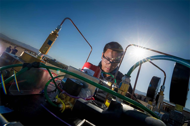 Photo of scientist preparing to launch a 3D-printed rocket