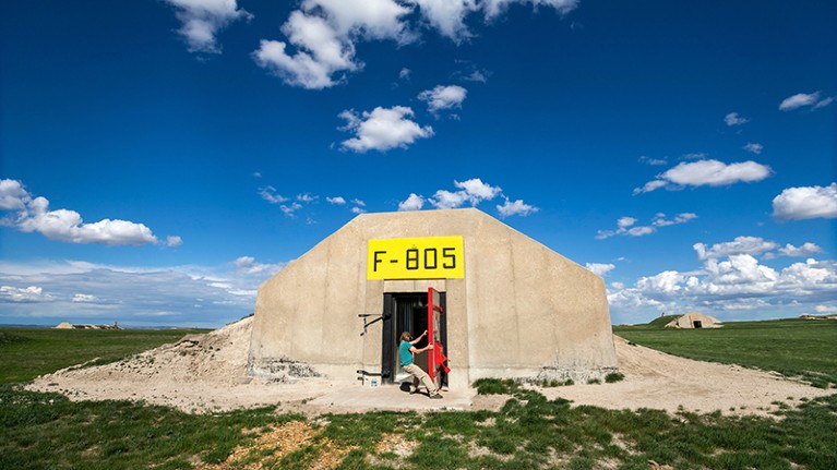 A person closes the door on a doomsday bunker converted to shelter civilians