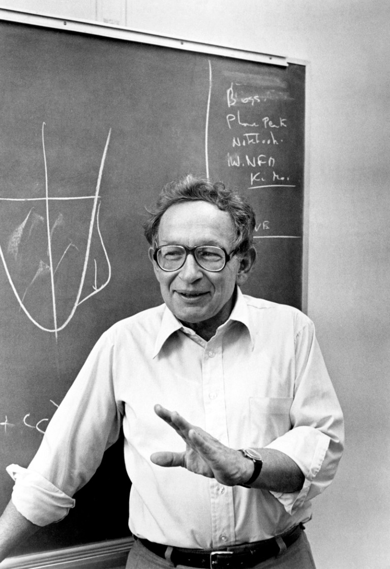 Portrait of Philip Anderson standing by a chalkboard