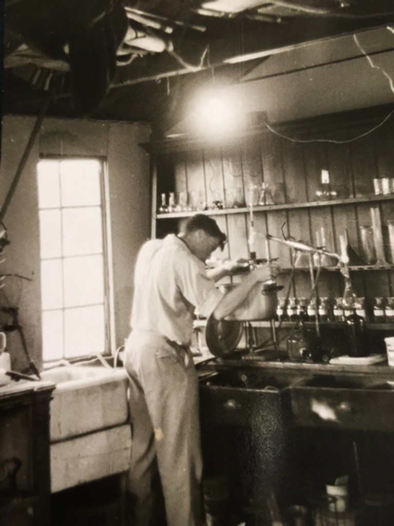 Julian Perry Robinson leans over a sink in the lab