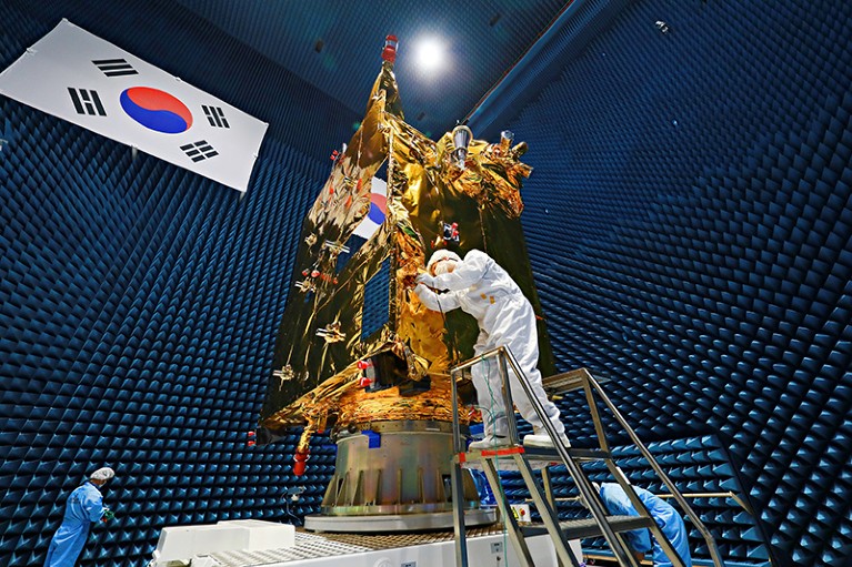 A worker in porotective clothes checks the Cheollian 2B satellite