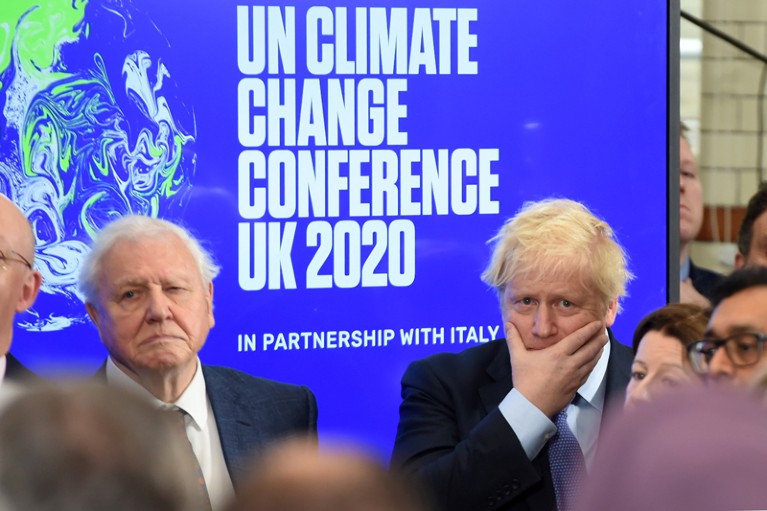 David Attenborough and Boris Johnson stand in front of signage at launch of the COP26 UN Climate Summit
