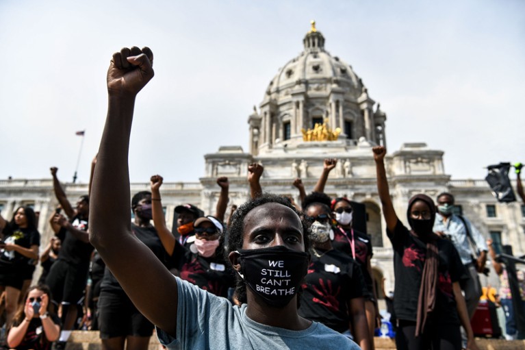 Demonstrators raise their fists outside the State Capitol of Minnesota during a protest over the death of George Floyd