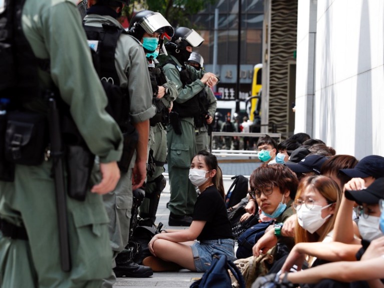 Anti-government demonstrators are detained by riot police, Hong Kong.