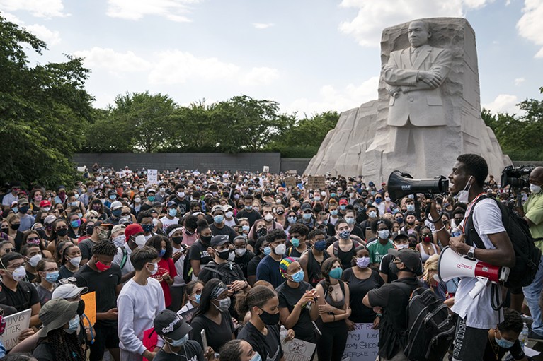 People gather at the Martin Luther King, Jr. Memorial in Washington DC during a protest against police brutality