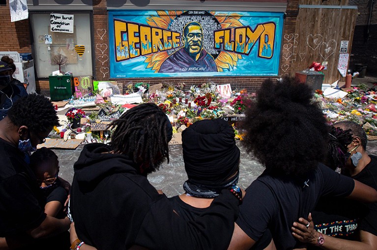 Mourners gather at a memorial where George Floyd was murdered by a Minneapolis police officer