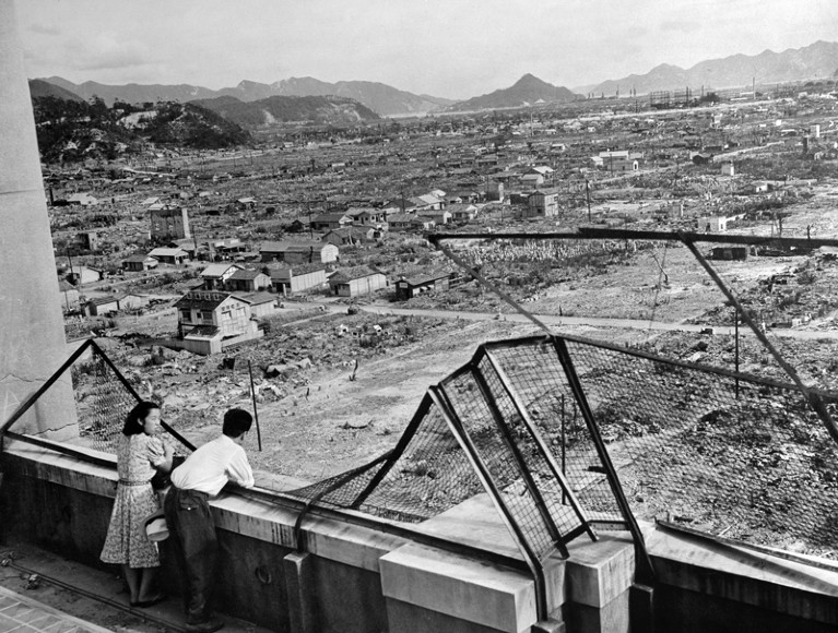 Photo dated 1948 shows a man and a woman looking over the devastated city of Hiroshima after the 1945 nuclear bombing