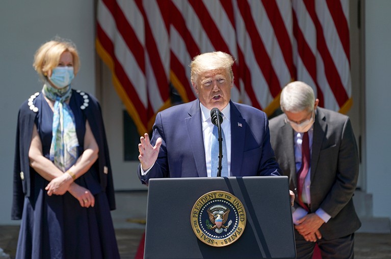 U.S. President Donald Trump speaks at a coronavirus press conference with Dr Birx and Dr Fauci in the background.