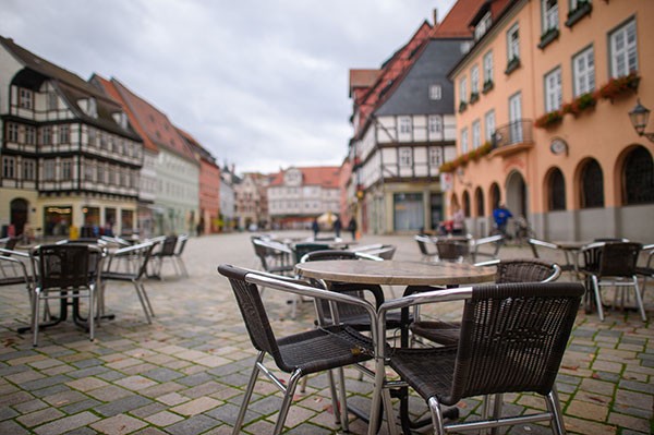Unoccupied tables and chairs of a closed coffee stand in Quedlinburg, Germany.